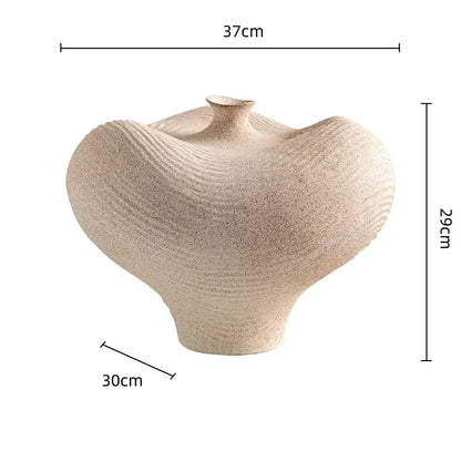 Beige textured geometric abstract ceramic vase with organic flowing curves and subtle horizontal ridges for living room decor
