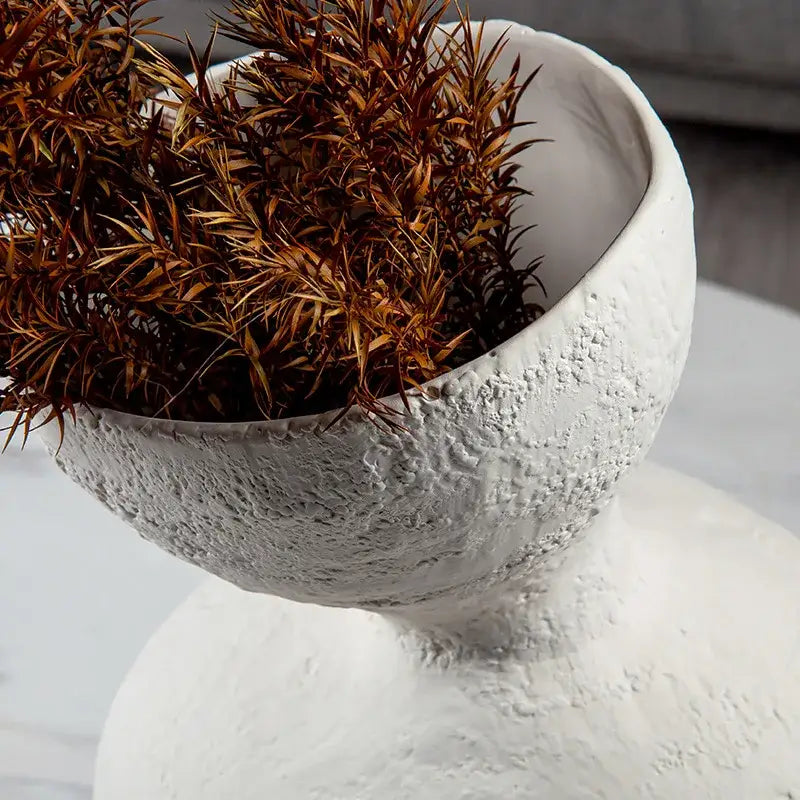 White textured ceramic bowl with fluted rim holding dried foliage for decorbites geometric abstract ceramic decor