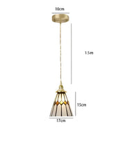 Gold-toned pendant light with amber and cream geometric stained glass shade for dining room glass pendant light
