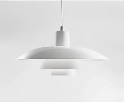 White minimalist pendant light with concentric circular shades and amber cream glass for dining room use