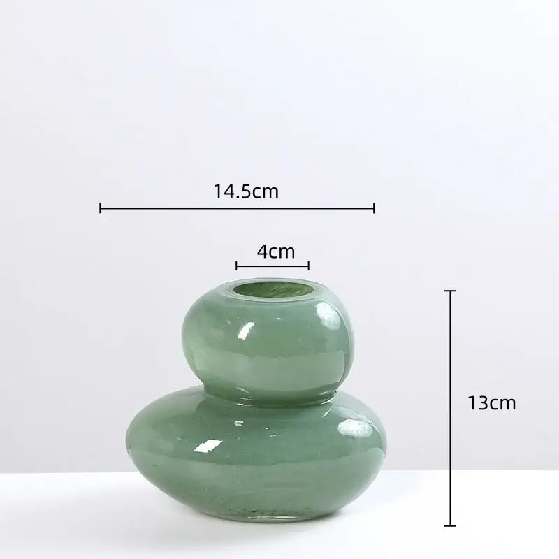 A sleek translucent sage green glass vase with a rounded double-hoop design for decorbites geometric glass stackable terrarium home decor