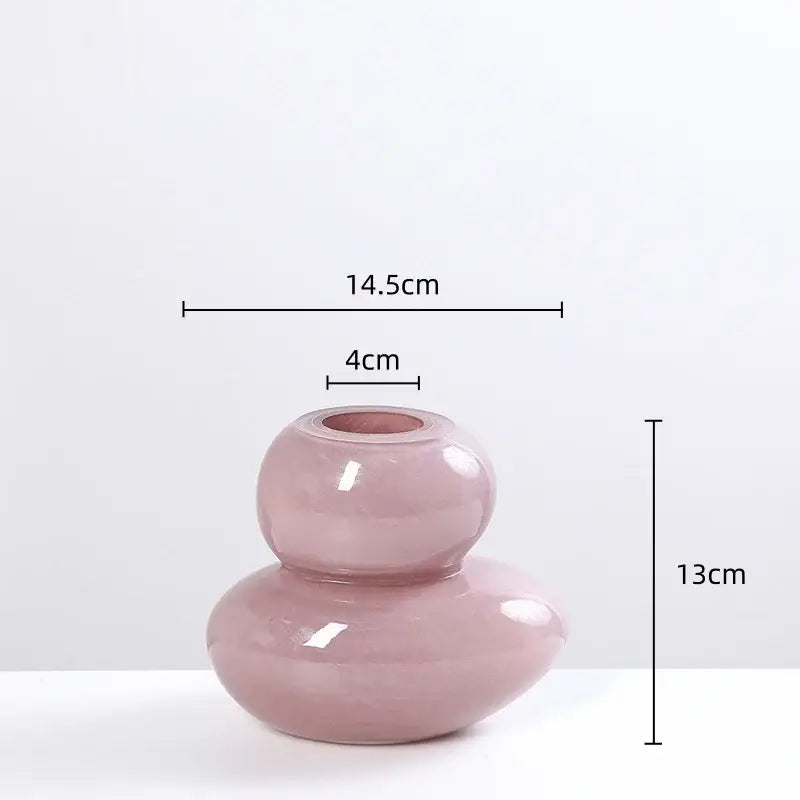 A sleek glossy pink ceramic vase with modern double-gourd design complementing decorbites geometric glass stackable terrarium home decor
