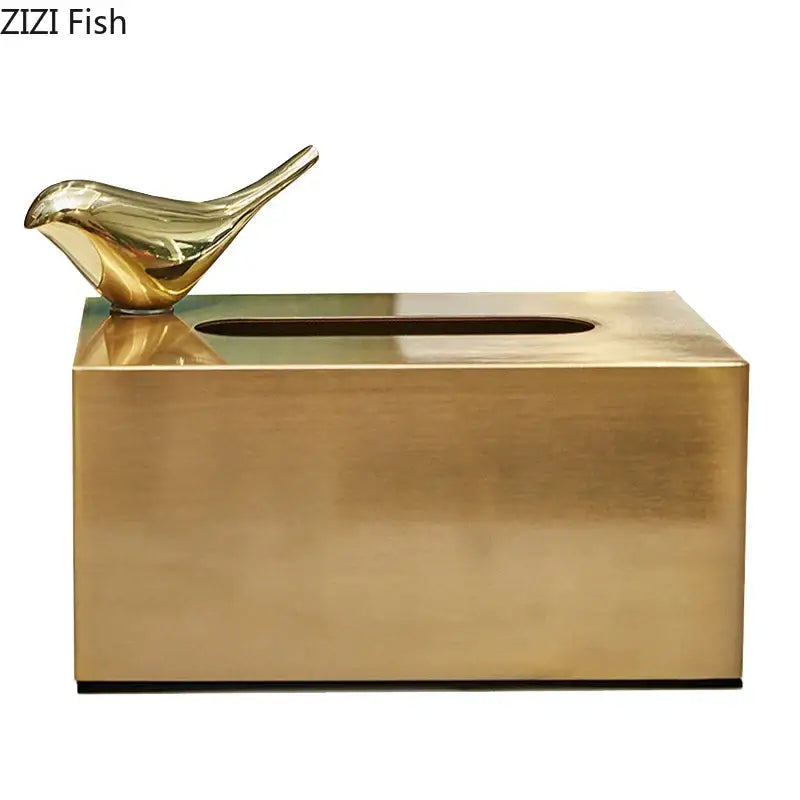 Gold-colored metallic tissue box with geometric animal bird figurine in brass color for living room decor by decorbites