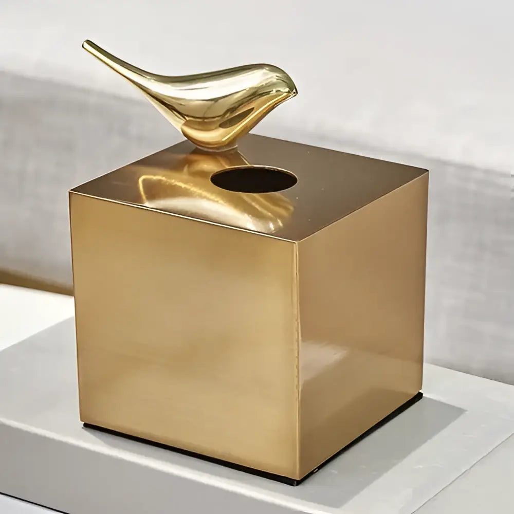 Gold-colored brass color minimalist geometric animal tissue box with sleek bird figurine for living room decor by decorbites
