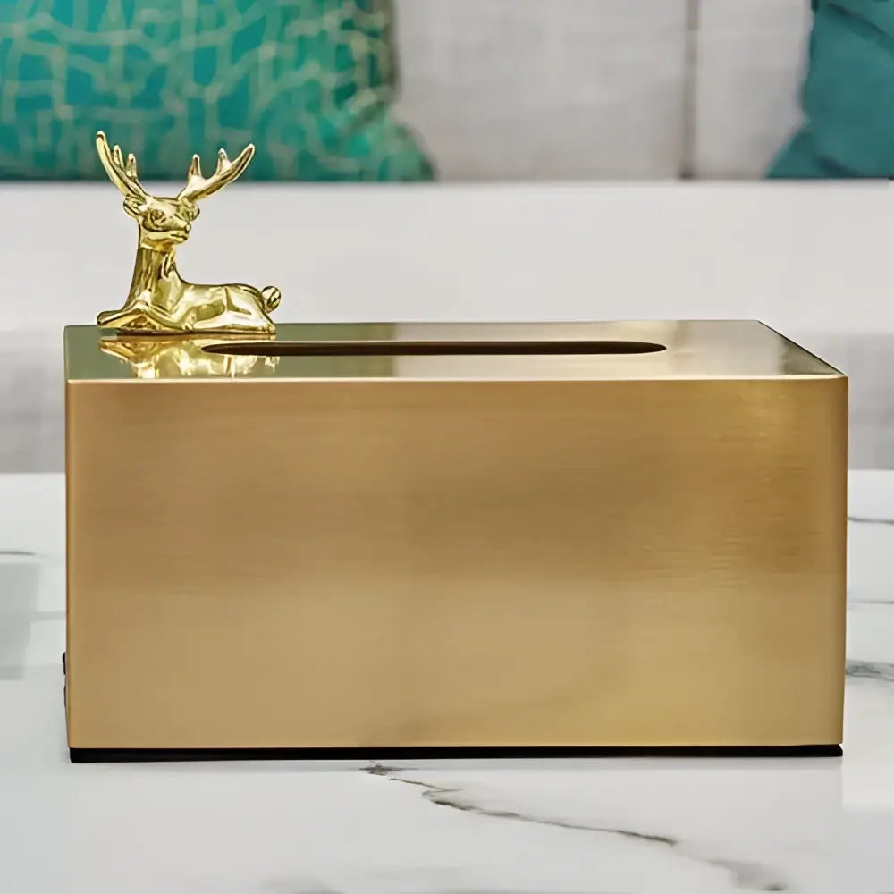 Gold-colored brass color tissue box with geometric animal deer figurine for living room decor by decorbites