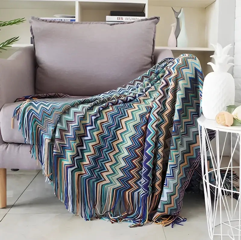 Colorful geometric aztec baja blanket with teal blue purple and orange zigzag knit and fringed edges for decorbites living room decor