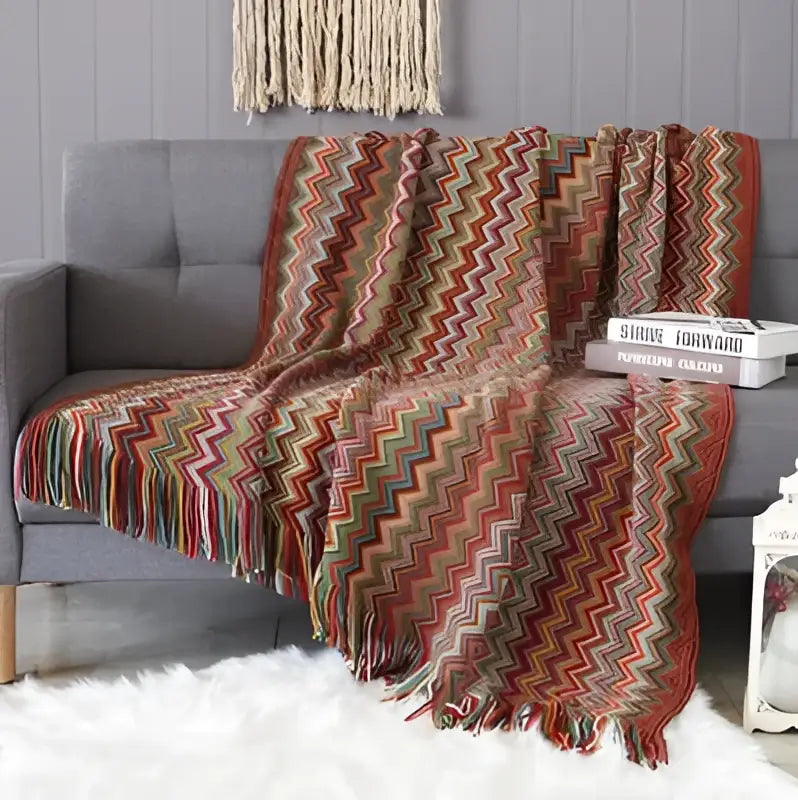 Cozy multicolored geometric aztec baja blanket with zigzag knit and fringe in mustard and blue decorbites living room throw