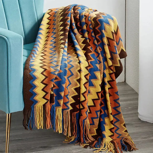 Cozy hand-knitted geometric aztec baja blanket in mustard yellow blue and burnt orange with matching fringe for decorbites decor