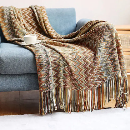 Cozy multicolored zigzag knit geometric aztec baja blanket with fringe in mustard and blue for living room decorbites