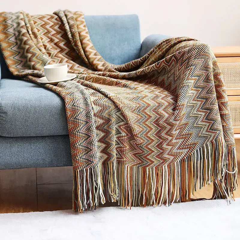 Cozy multicolored zigzag knit geometric aztec baja blanket with fringe in mustard and blue for living room decorbites