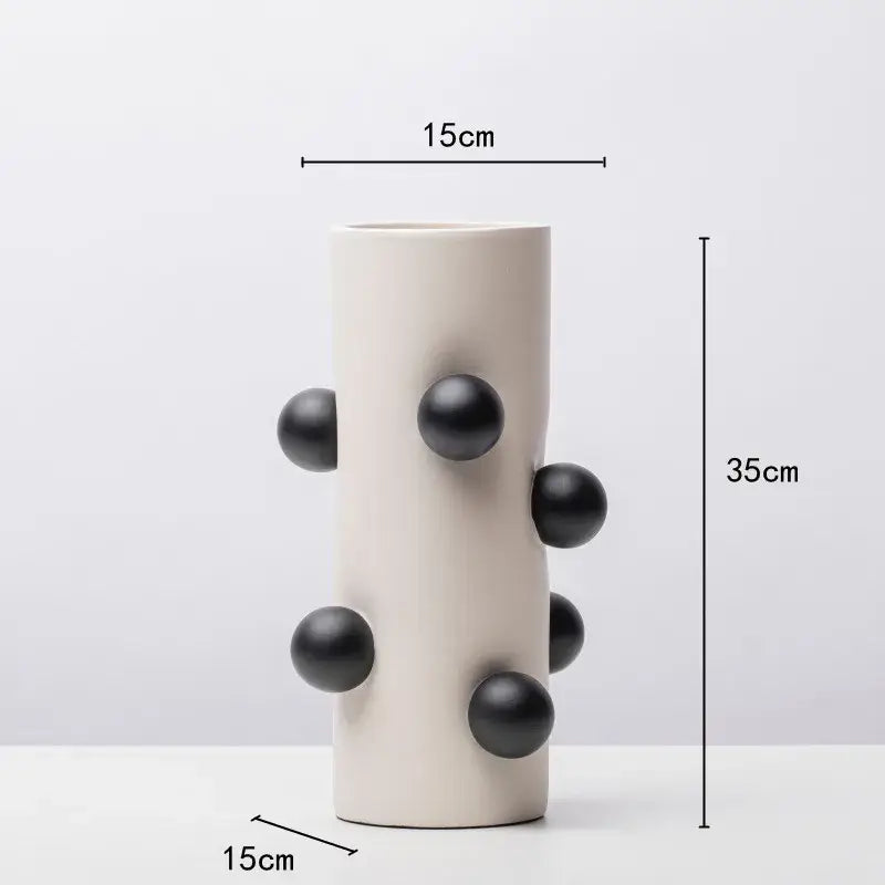 Cream-colored ceramic geometric ball vase with six glossy black spheres for living room decor by decorbites geometric ball