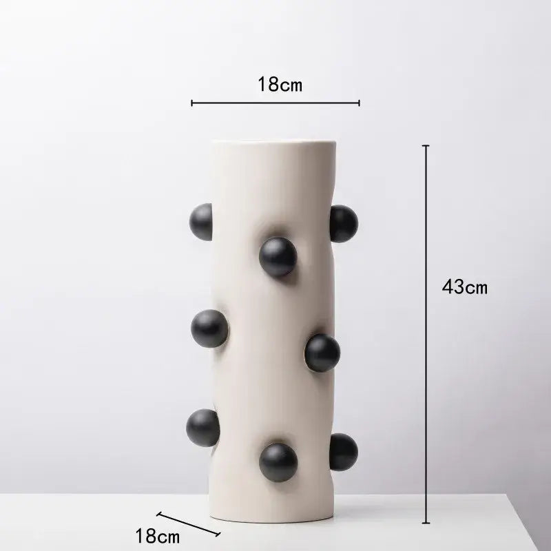 Cream-colored ceramic geometric ball vase with black spherical protrusions for living room decor by decorbites geometric