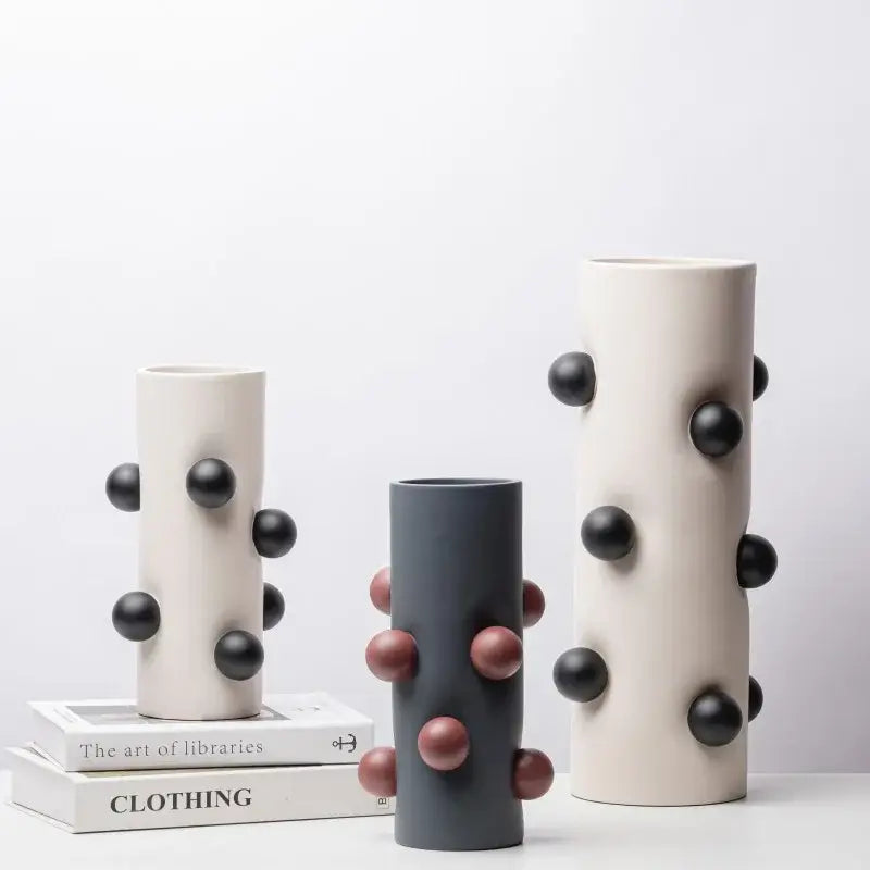 Three cylindrical ceramic geometric ball vases in cream and gray with black and rose gold embellishments for decorbites decor