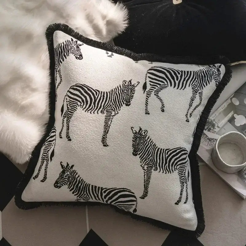 Square white pillow cover set with black zebra silhouettes and fringed black border for living room decor