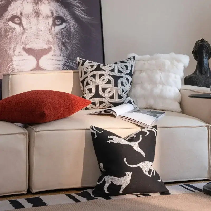 Geometric black and cream jacquard pillow cover set featuring a black pillow with white leaping cat pattern for living room