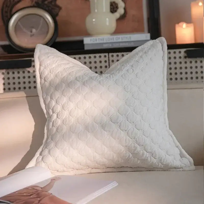 White quilted throw pillow with subtle diamond stitching in geometric black and cream jacquard pillow cover set