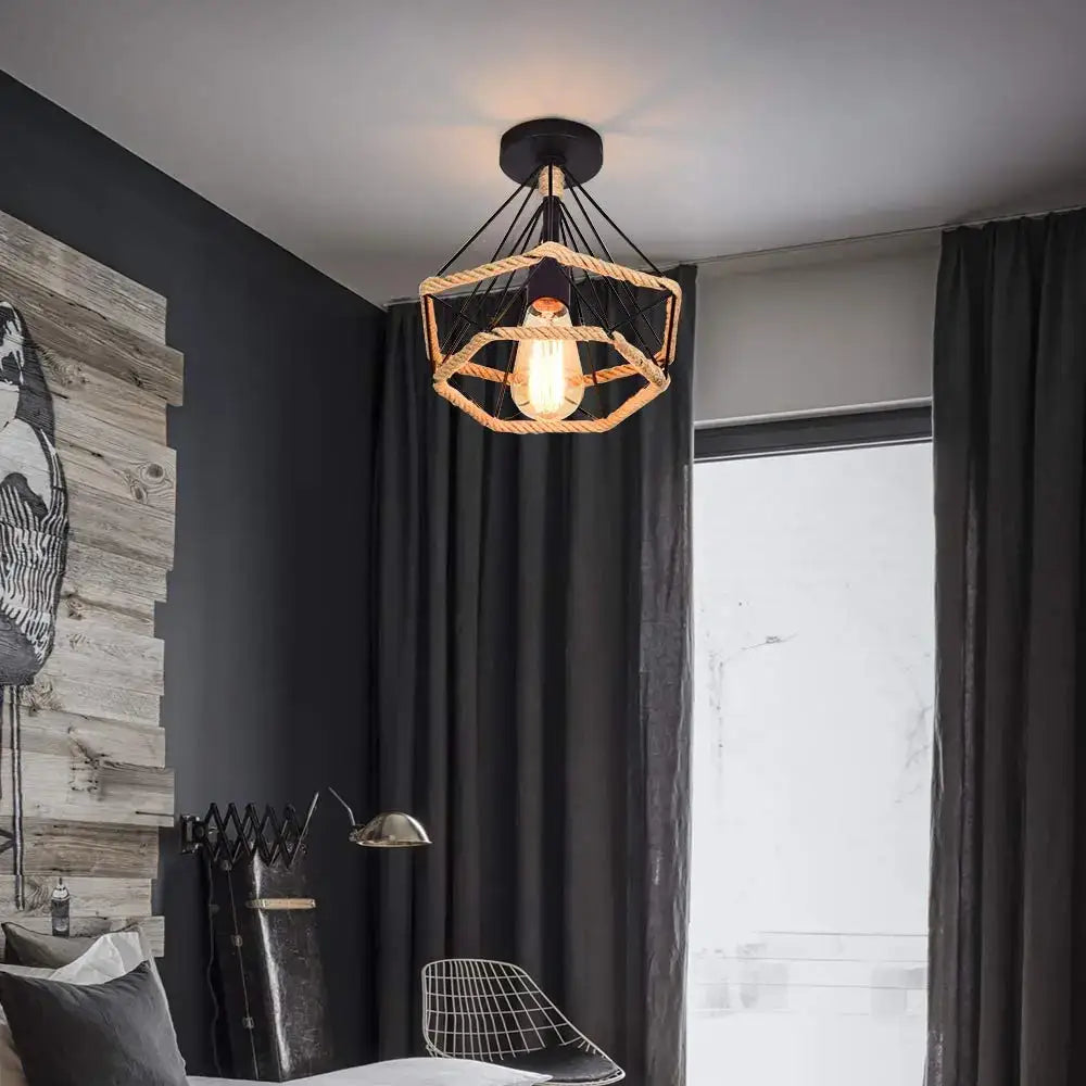 Industrial-style black cage iron pendant light with hexagonal woven rope frame and exposed edison bulb for dining room
