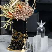 Black and gold plated hollowed vase with geometric perforated ceramic design for living room decorbites gold plated decor