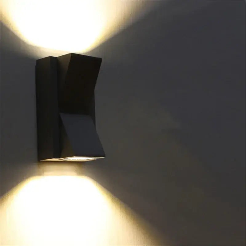 Geometric black led outdoor wall light with dual angled light beams for modern outdoor wall light decoration