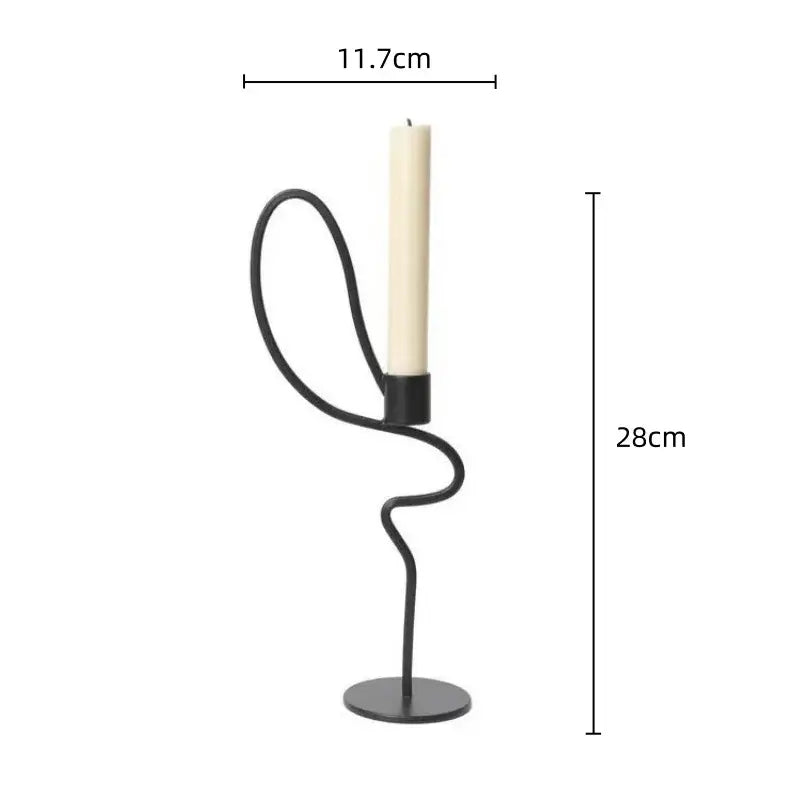Black wrought iron candlestick candelabrum with sleek curved design and ivory taper candle for dining room decorbites geometric black centerpiece