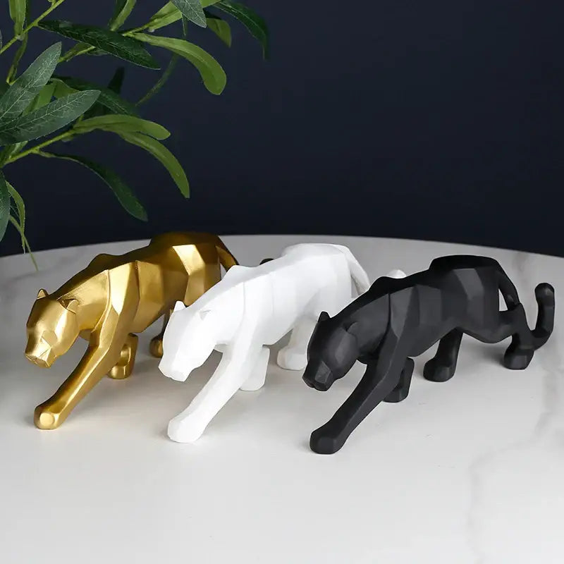 Three sleek geometric panther resin figurines in gold white and black for decorbites black panther living room decor
