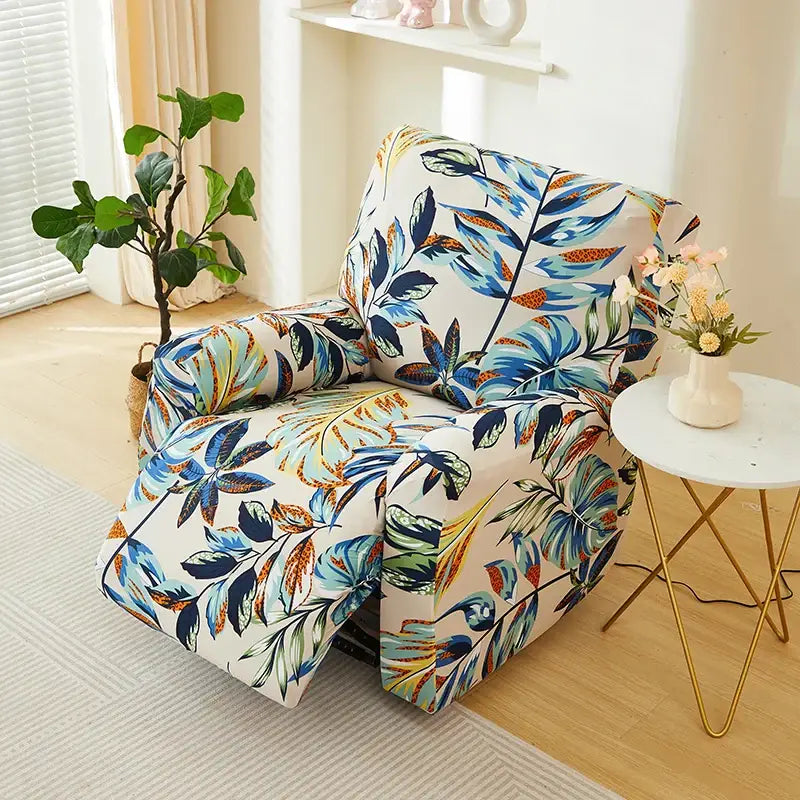 Geometric black and red stretch recliner cover with vibrant tropical leaf pattern in blue green and orange on cream background