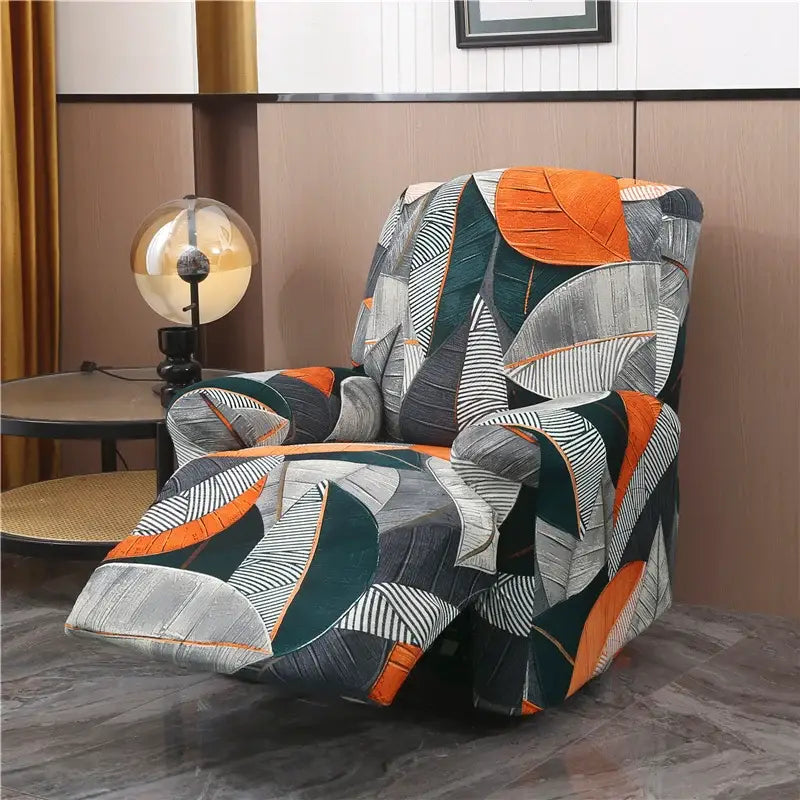 A vibrant stretchy fabric recliner cover with bold tropical leaf pattern in orange gray black and teal for living room
