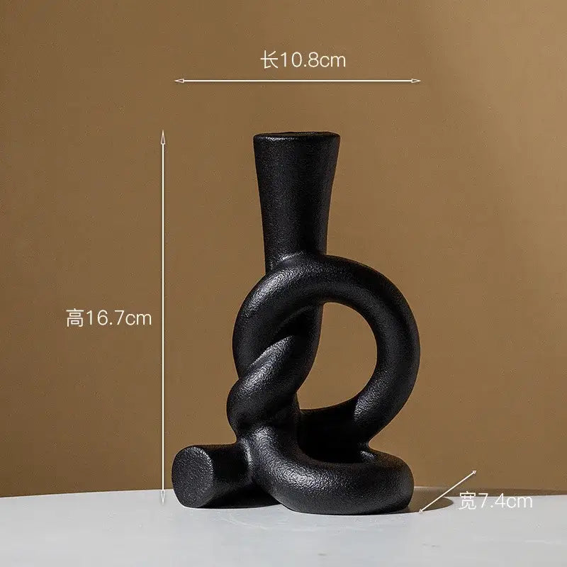 Black matte ceramic candle stand with abstract twisted knot design by decorbites for modern home decor