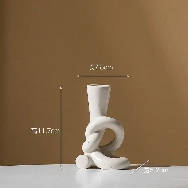 Minimalist white ceramic candle stand with abstract intertwined knot design for home decor by decorbites ceramic knot