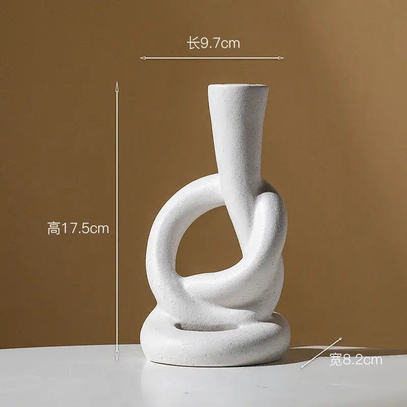 White ceramic knot candle stand with abstract intertwined ring design for home decor by decorbites ceramic knot