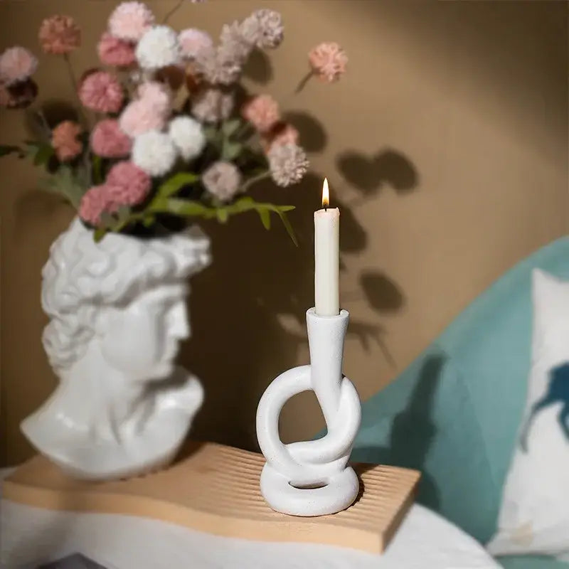 White ceramic candle stand with twisted knot design for home decor by decorbites ceramic knot collection