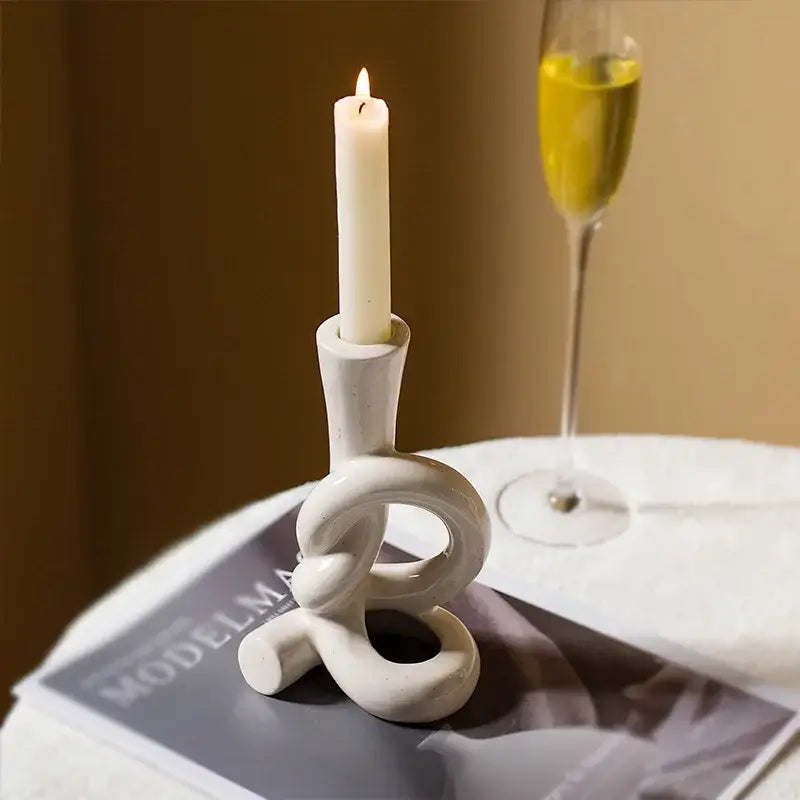 White ceramic candle stand with twisted knot design for home decor featuring decorbites ceramic knot style