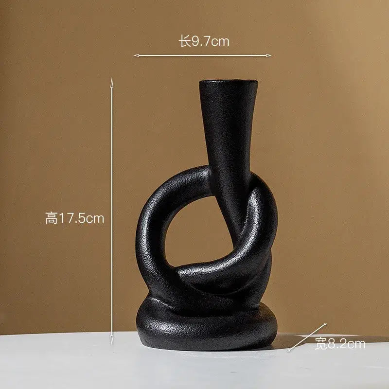 Black matte ceramic candle stand with abstract twisted ring design for home decor by decorbites ceramic knot