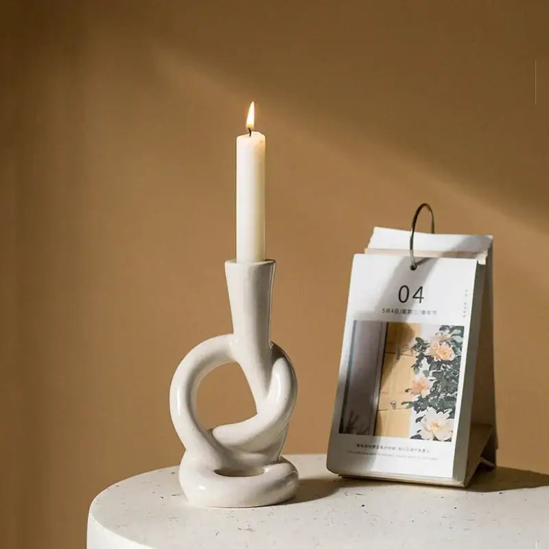Minimalist white ceramic candle stand featuring an abstract intertwined knot design for home decor by decorbites ceramic knot