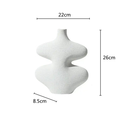 A white textured ceramic vase with abstract undulating curves and a narrow neck in decorbites geometric ceramic set