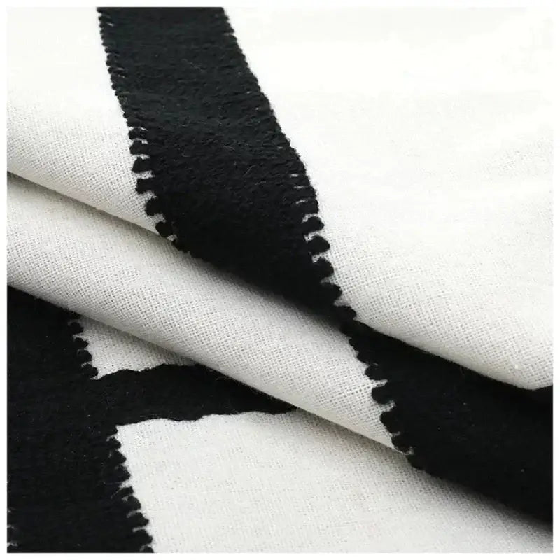 Geometric black and white embroidered burlap cushion cover with bold pattern and stitched edges for living room decor