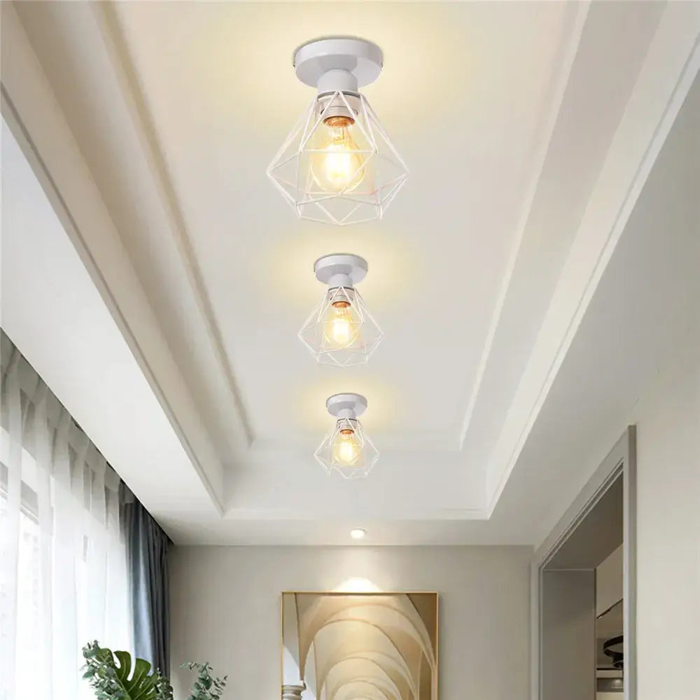 White geometric cage-style iron frame pendant chandelier with exposed filament bulb for dining room decorbites iron frame