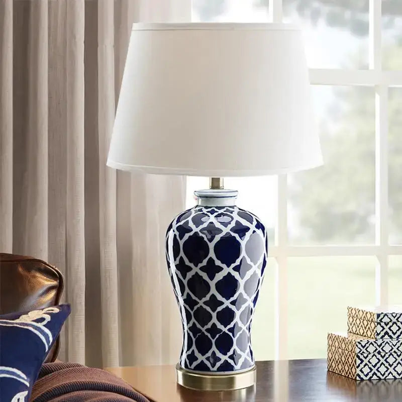 Geometric blue ceramic table lamp with white pattern and gold base for bedside table in bedroom decor
