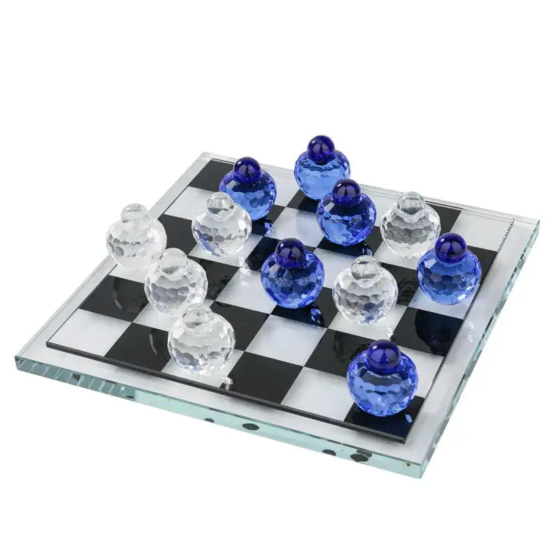 A clear and blue faceted glass chess set on a black and white checkered glass board for living room decor