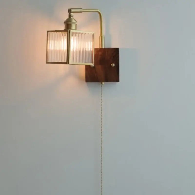 Brass led wall light with geometric blue glass shade and dark wood backplate for dining room decorbites brass led sconce