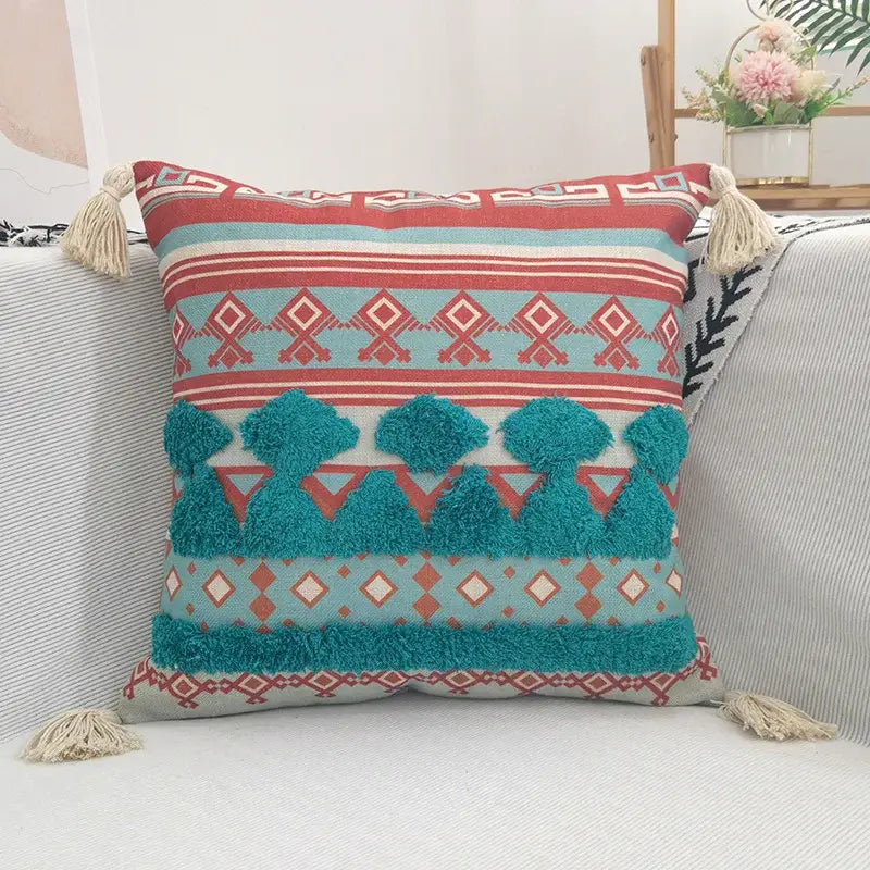 Square throw pillow case with vibrant geometric bohemian pattern, textured pom-poms, and mustard yellow tassels for decorbites living room decor