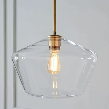 Clear glass pendant light with brass-finished metal rod and exposed edison bulb in geometric brass glass pendant lights set