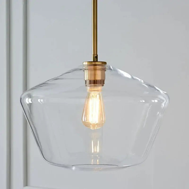 Clear glass pendant light with brass-finished metal rod and exposed edison bulb in geometric brass glass pendant lights set