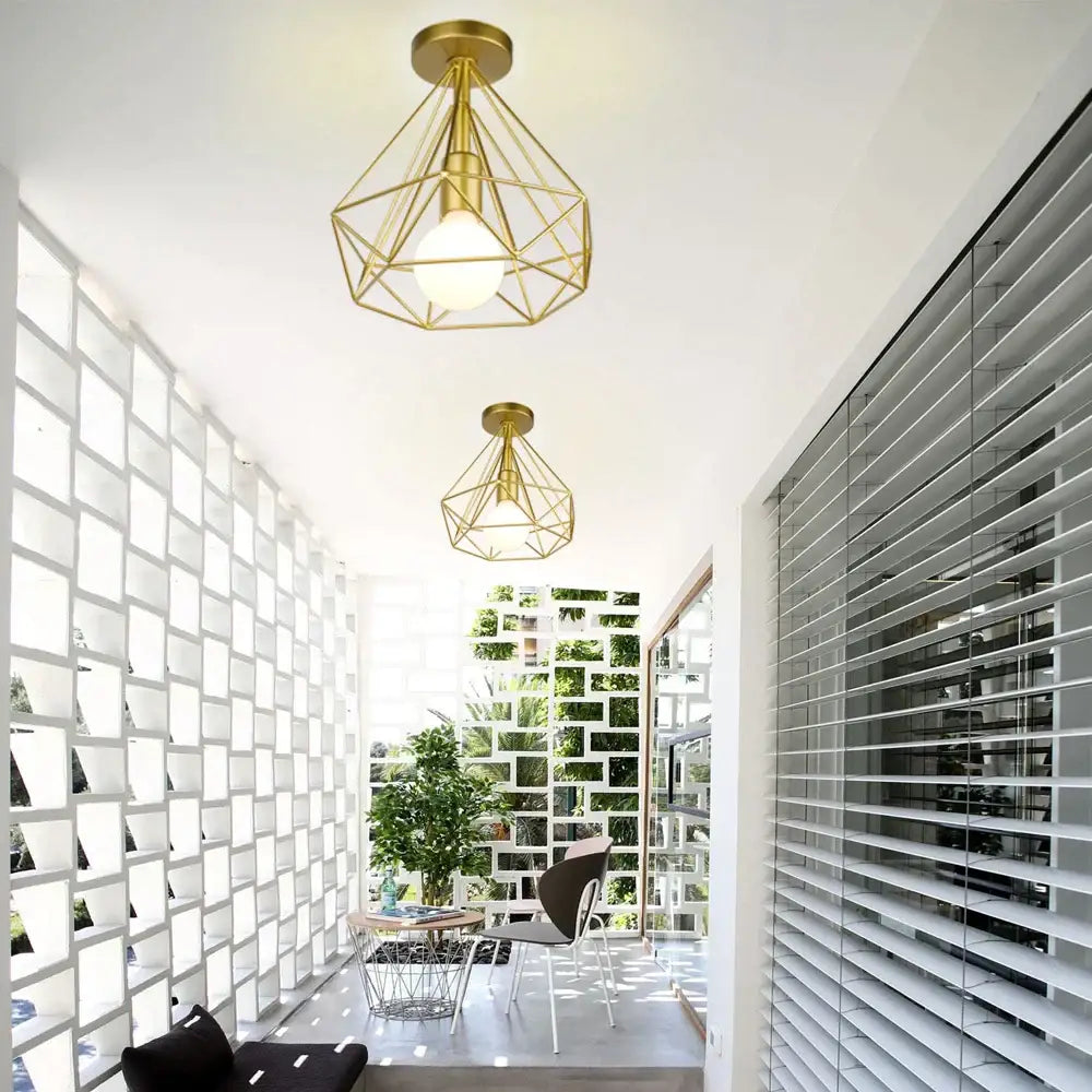 Gold geometric cage iron ceiling light fixture with frosted glass bulbs for dining room exposed bulb lighting