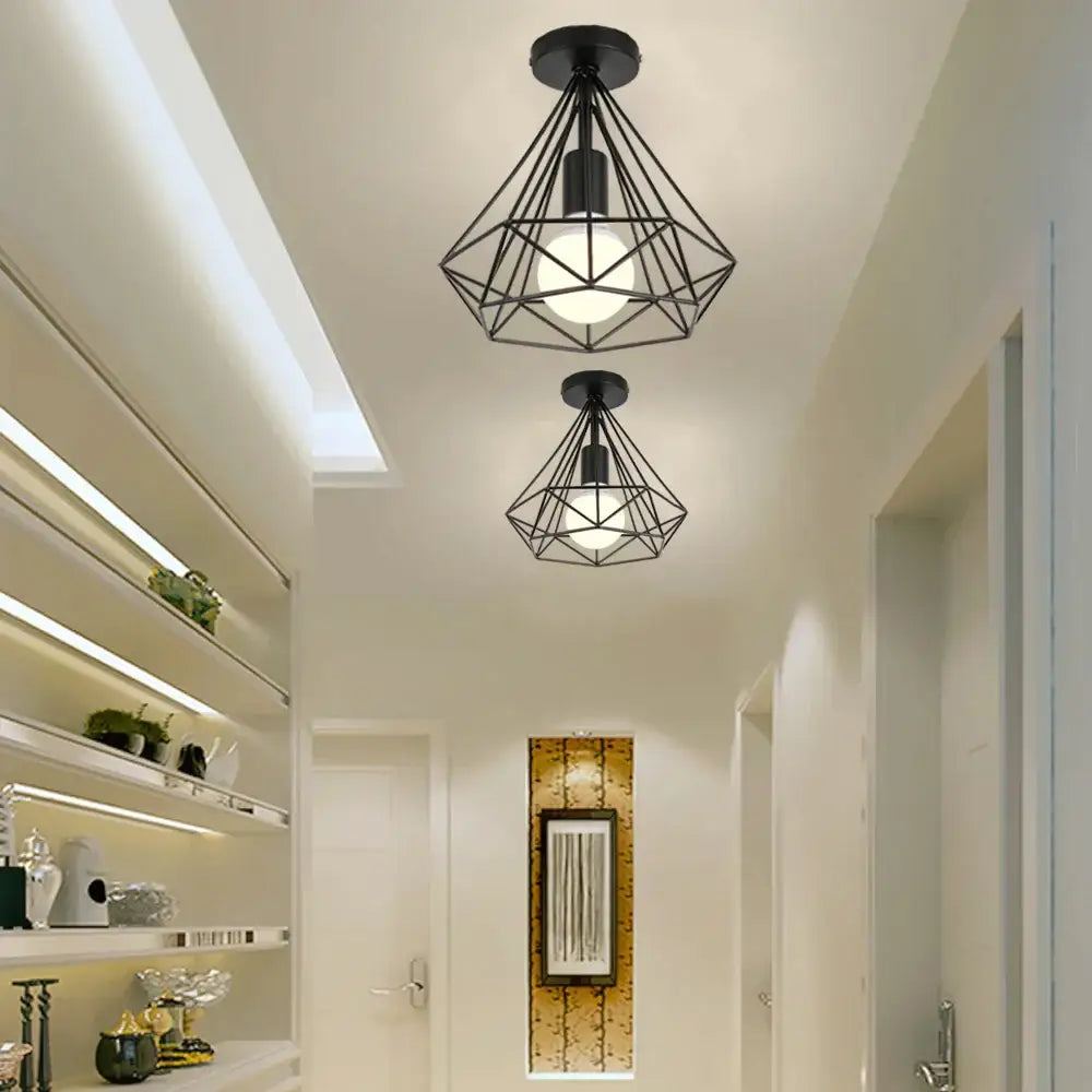 Black geometric wireframe ceiling light fixture with iron cage design and exposed bulb for dining room use