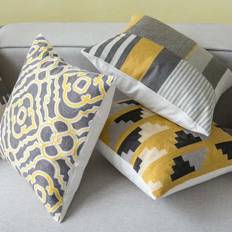Three decorative throw pillows with embroidered geometric canvas cotton cushion cover in yellow and grey for living room decorbites