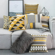 A cozy gray faux fur throw pillow on a sofa with decorbites geometric canvas cotton yellow cushion cover