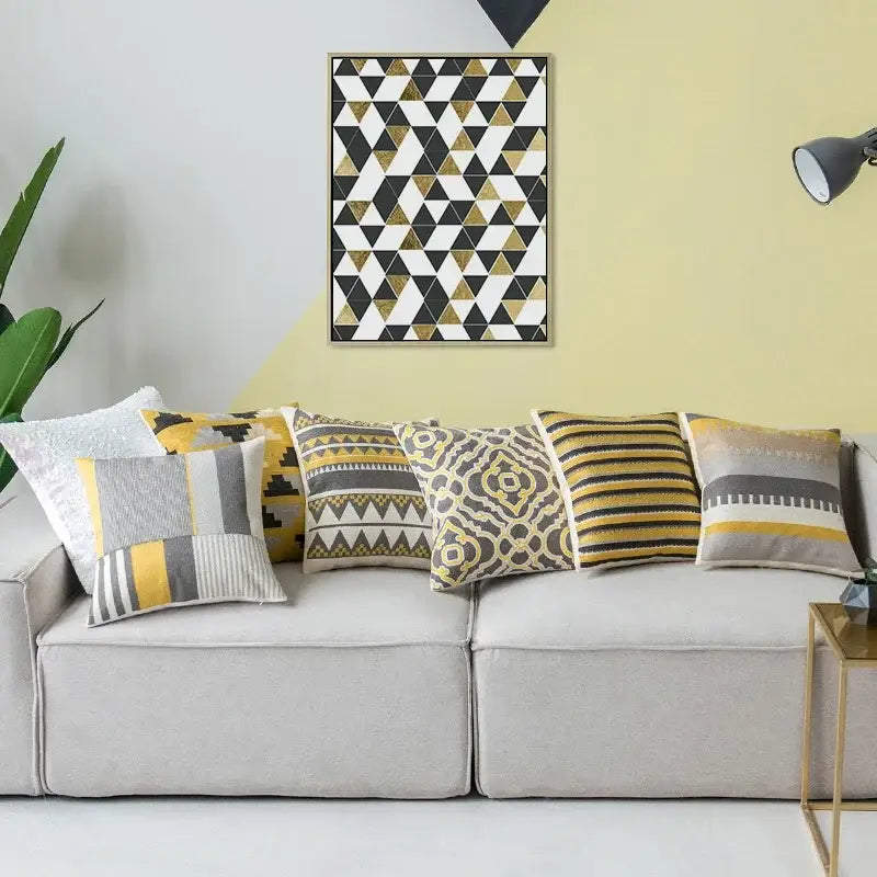 A collection of decorbites geometric canvas cotton cushion covers in yellow and grey with modern geometric patterns