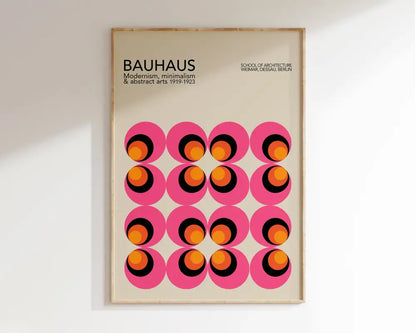 A framed decorbites bauhaus geometric canvas print featuring pink circles with orange and black rings on off-white background