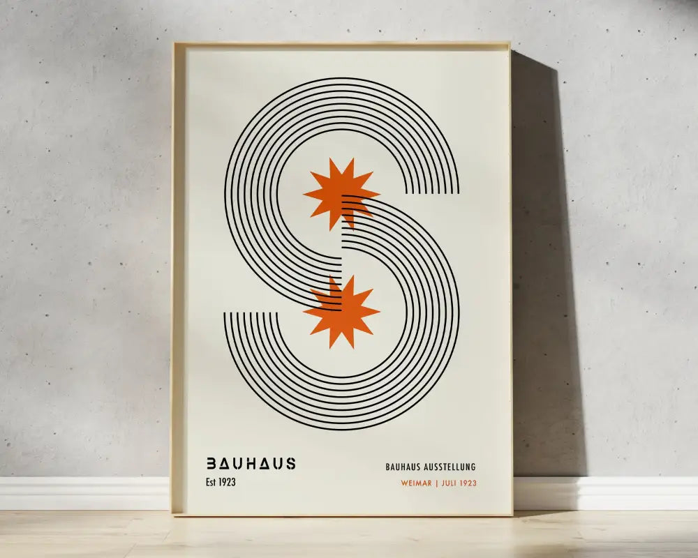 Minimalist framed bauhaus geometric canvas print with bold black s and orange starbursts for modern home decor